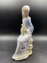 A Lladro Seated Lady With Flowers 10 Inches High