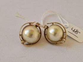 A Nice Pair Of Mabe Pearls And White Stone Earrings Set In Gold