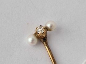 A Diamond And Pearl Stick Pin