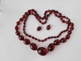 A String Of Faceted Red Bead Necklace And Earrings