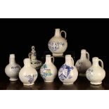 A Group of Seven 17th Century Style Blue & White Delft Baluster Wine Bottles; six stamped with