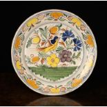 An 18th Century Polychrome Glazed Delft Charger (A/F) decorated with a bird and flowers in a border