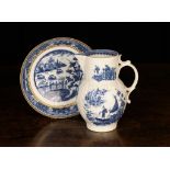 A Caughley Jug & Dish. The leaf moulded baluster jug printed in blue with a Chinese fisherman