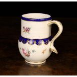 A Chelsea-Derby Porcelain Mug, Circa 1770-80. The globular body and finely ribbed cylindrical neck
