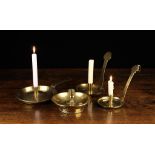 Four Antique Sheet Brass Chamber Sticks: An 18th century candle holder having a moulded candle cup