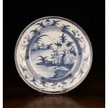 A London Delft Blue & White Charger, Circa 1760. The centre panel painted with a chinoiserie scene