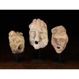 Three Small Ornamental Sandstone Architectural Fragments carved in the form of male gargoyles with