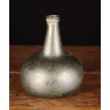 A Late 17th Century Green Glass Onion Bottle with kick up base, 7" (18 cm) in height.