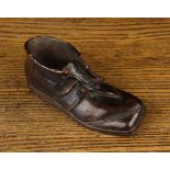 A 19th Century Carved Treen model of a Boot, 4¼" (11 cm) in length.
