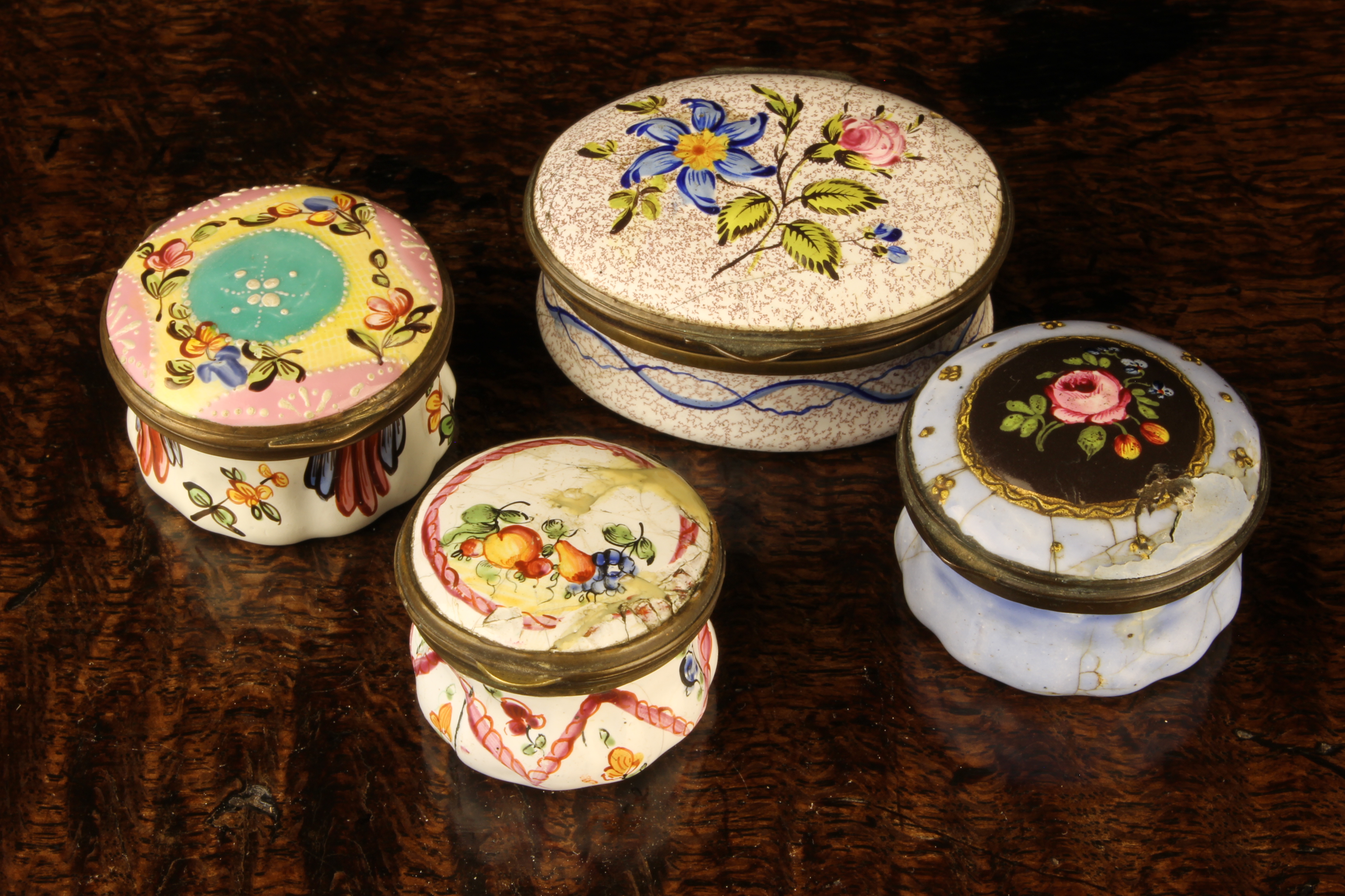 Four Bilston Enamel Patch Boxes decorated with flowers (A/F): One oval with a pink rose & blue