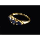 A 14 Carat Gold Ring set with three sapphires.