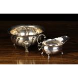 A Silver Metal Bowl with embossed wrythen fluting radiating out from the centre to a serpentine rim,
