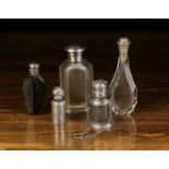 A Group of Five Antique Scent Bottles: A clear glass bottle with facet cut sides and a screw-on