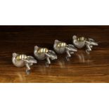 A Set of Four Novelty White Metal Salts cast in the form of upturned snail shells with gilt