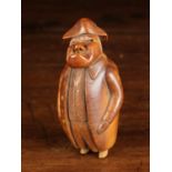 A Late 18th/Early 19th Century Coquilla Nut Snuff Box carved in the form of a man: His curmudgeonly