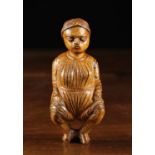 A 19th Century French Treen Tobacco Box carved in the form of a squatting woman with a hinged lid