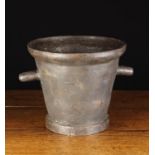A Large 19th Century Cast iron Mortar with protuberant handles either side, 11½" (29 cm) high,