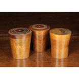 Three 19th Century Turned Fruitwood Lidded Boxes of tapered cylindrical form;