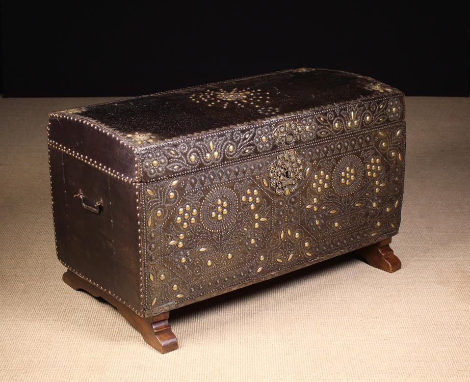 A Fabulous Late 17th Century Leather Clad Travelling Trunk lavishly adorned with studded brass