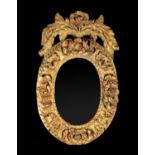 A Small 19th Century Gilded Oak Oval Frame carved with flowers & leaves and surmounted by a floral