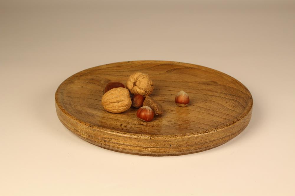 An 18th or Early 19th Century Elm Platter, possibly Welsh, of circular form gone slightly oval.