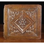 A Fine Elizabethan Carved Oak Panel centred by a flower head in a lozenge reserve with stepped