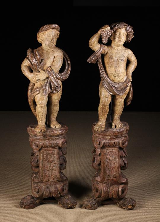 A Pair of Delightful Early 18th Century Carved & Polychromed Wooden Putti on integral Stands.