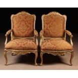 A Pair of 19th Century Carved & Gilded Armchairs in the Louis XV Style.