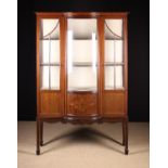 An Edwardian Inlaid Mahogany Display Cabinet having a glazed bowfront centre section flanked by