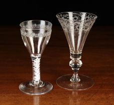 A Trumpet Bowled Wine Goblet engraved with a border of scrolling foliage on a baluster knopped stem