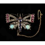 A Charming Victorian/Edwardian Butterfly Brooch set with opals, diamond chips, rubies and sapphires.