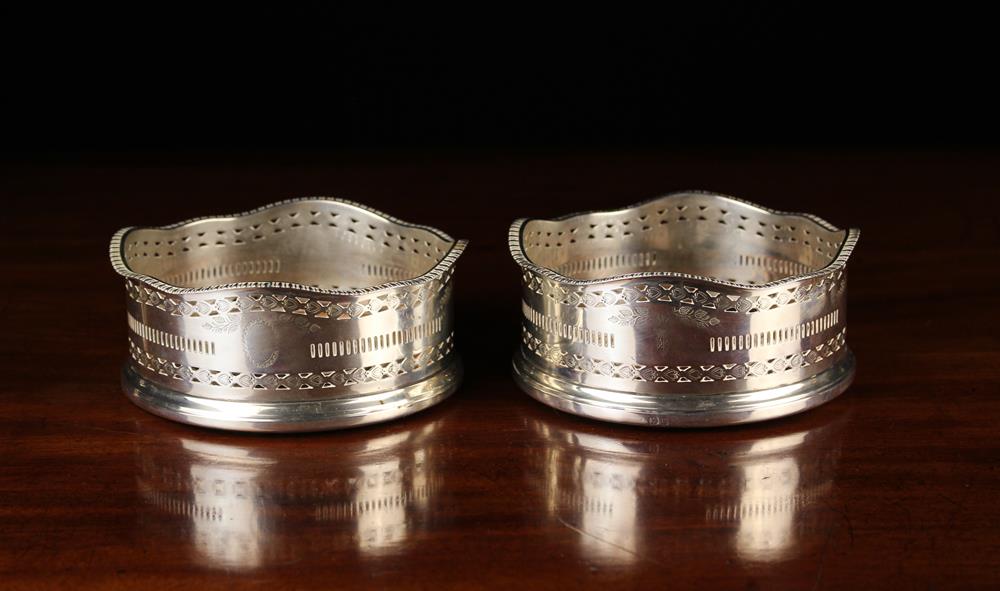 A Pair of Silver Wine Coasters.