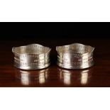 A Pair of Silver Wine Coasters.