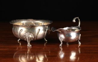 A Silver Metal Bowl with embossed wrythen fluting radiating out from the centre to a serpentine rim,