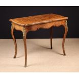 A 19th Century Figured Walnut Flip-top Card Table inlaid with tulipwood cross-banding edged in