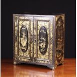 A Small Japanned Lacquer Collector's Cabinet enriched with gilded Chinoiserie decoration on a black