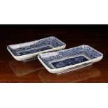 A Pair of Chinese Blue & White Rectangular Dishes decorated with flowers and foliage to the centre