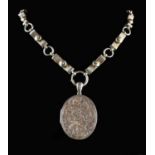 A Large Victorian/Edwardian Silver Coloured Locket on an interesting chain.