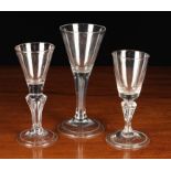Three Funnel-bowled Glass Goblets: One with an air tear to the stem 6¼" (16 cm) in height,