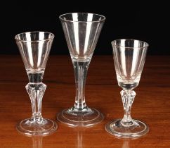 Three Funnel-bowled Glass Goblets: One with an air tear to the stem 6¼" (16 cm) in height,