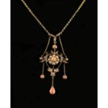 A Charming Victorian/Edwardian Pearl and Coral Pendant with gold coloured necklace.