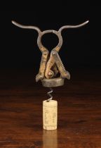A Heeley's 1890 Patent Empire Double Lever Corkscrew with residual bronze finish and a simple wire