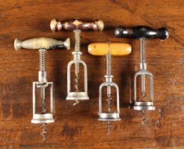 Four 19th Century Spring Assist Corkscrews with turned wooden handles;