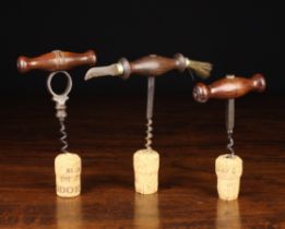 Three 19th Century Straight-pull Corkscrews: One fitted with a wire cutter to one end of the turned