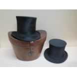 A Victorian leather top hat box with a tall brushed silk top hat - approx size 7 and a collapsible