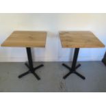 A pair of new wooden top café tables on steel bases - Height 75cm x 50cm x 60cm