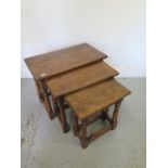 A nest of three oak side tables - Height 48cm x 61cm x 34cm