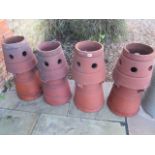 A set of four terracotta chimney pots - Tallest 72cm