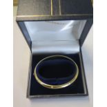 An 18ct hallmarked diamond hinged bangle 6cm x 6.5cm external, approx weight 14 grams - generally