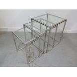 A nest of three chrome and glass side tables - Height 55cm x 45cm x 45cm